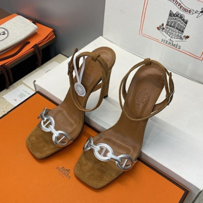 Hermès Ilot 85 Sandals in a warm gold suede and silver leather colorway.