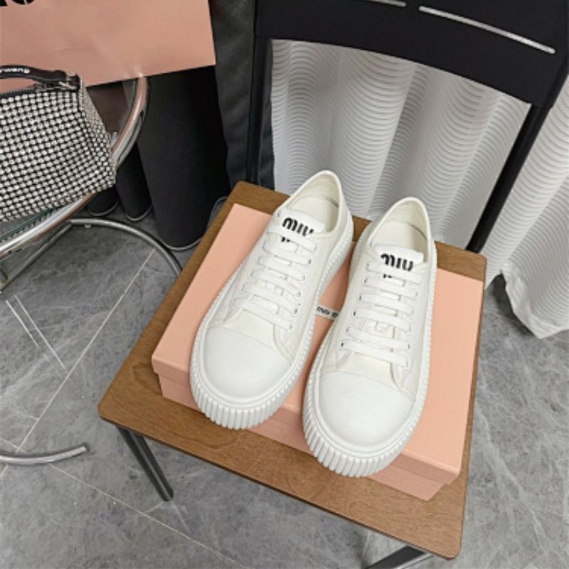 Miu Miu white canvas platform sneakers.