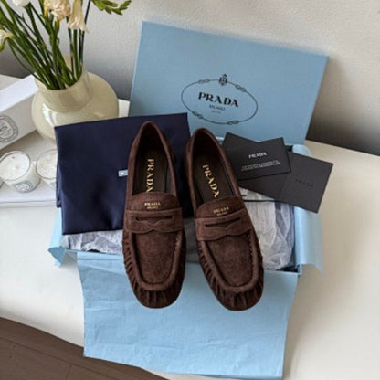 Prada Suede Driver Loafers in a rich chocolate brown ("Moro") colorway.