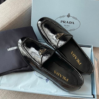 Prada Crinkled Patent Leather Loafers in classic black ("Nero").