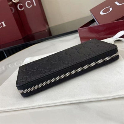 Gucci GG Emblem zip-around wallet in black embossed leather.