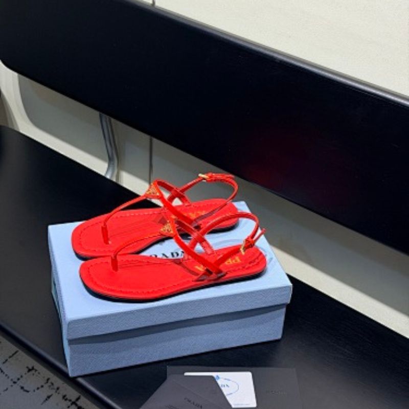 Prada Patent Leather Thong Sandals in a vibrant fiery red ("Fuoco") colorway.