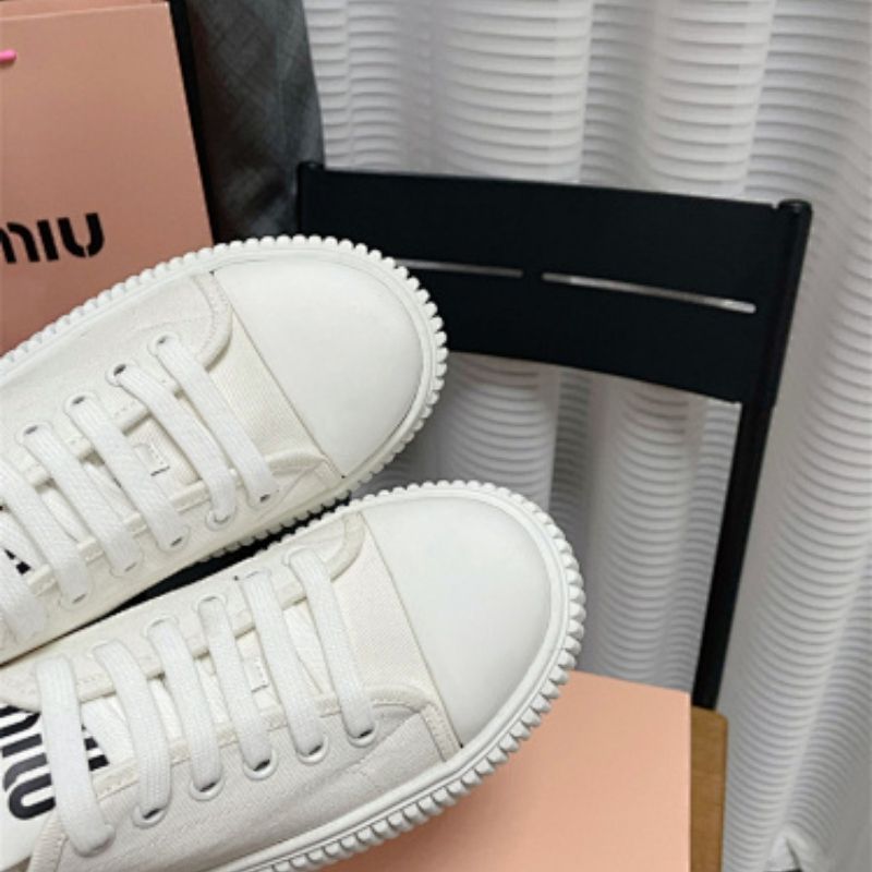 Miu Miu white canvas platform sneakers.