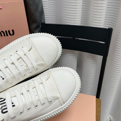 Miu Miu white canvas platform sneakers.