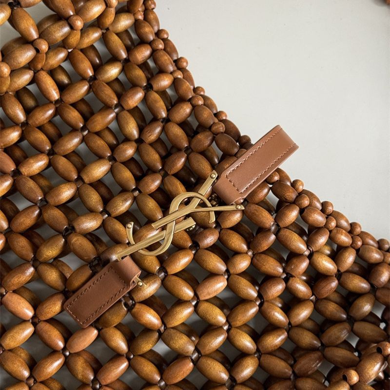 Saint Laurent Le 5 à 7 supple large bag made from wood beads.
