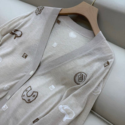 Hermès beige knitted cardigan with whimsical patches,