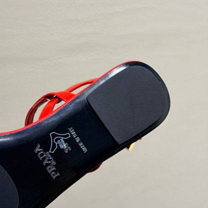 Prada Patent Leather Thong Sandals in a vibrant fiery red ("Fuoco") colorway.