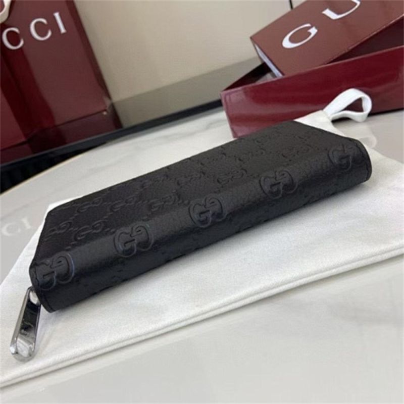 Gucci GG Emblem zip-around wallet in black embossed leather.