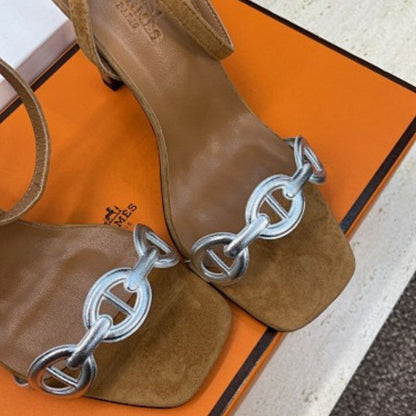 Hermès Ilot 85 Sandals in a warm gold suede and silver leather colorway.