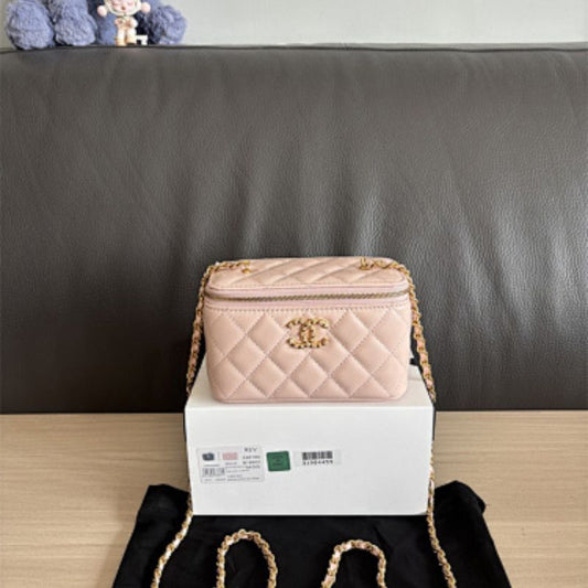 Chanel Small Classic Quilted Vanity Case in a light pink hue.