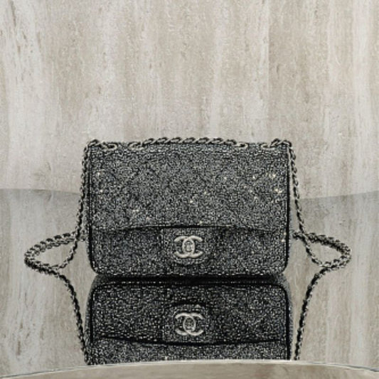 Chanel Rectangular Mini Flap Bag in black glitter.