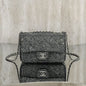 Chanel Rectangular Mini Flap Bag in black glitter.