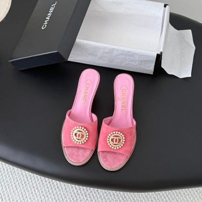 Chanel Pearl-Embellished Interlocking CC Suede Mules in bright pink.