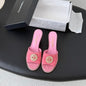 Chanel Pearl-Embellished Interlocking CC Suede Mules in bright pink.