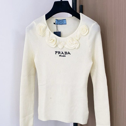 Prada ribbed knit sweater with floral appliqués on the collar
