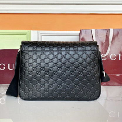Gucci GG Emblem Medium Crossbody Bag in black embossed GG leather.