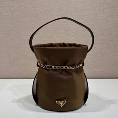 Prada Arqué Re-Nylon and Leather Bucket Bag in a rich cocoa brown.