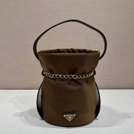 Prada Arqué Re-Nylon and Leather Bucket Bag in a rich cocoa brown.