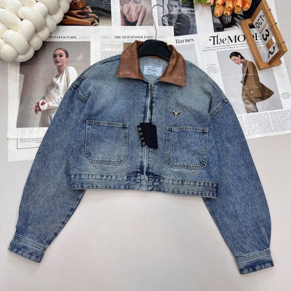 Prada cropped denim jacket with a brown leather collar.