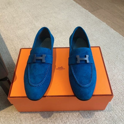 Hermès Paris Loafers in a striking monochromatic blue suede layout.