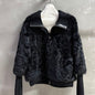 Christian Dior  faux-fur jacket featuring contrasting black knit sleeves, collar, and hem
