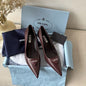 Prada 75mm Padded Triangle-Logo Leather Pumps.