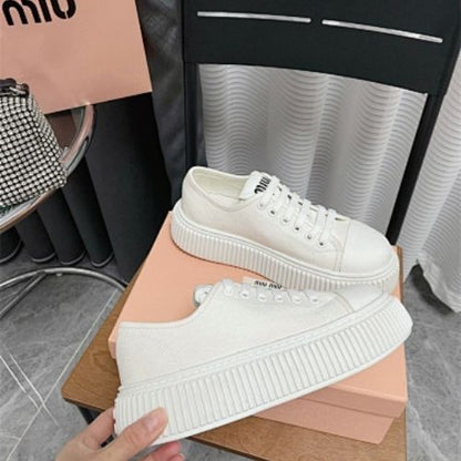 Miu Miu white canvas platform sneakers.