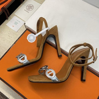 Hermès Ilot 85 Sandals in a warm gold suede and silver leather colorway.