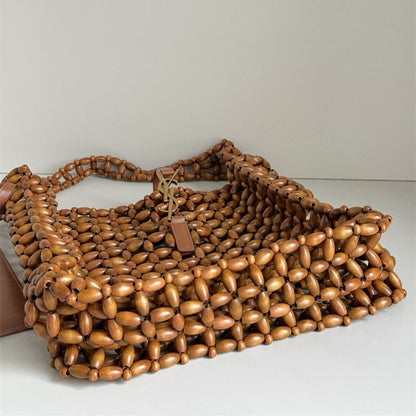 Saint Laurent Le 5 à 7 supple large bag made from wood beads.