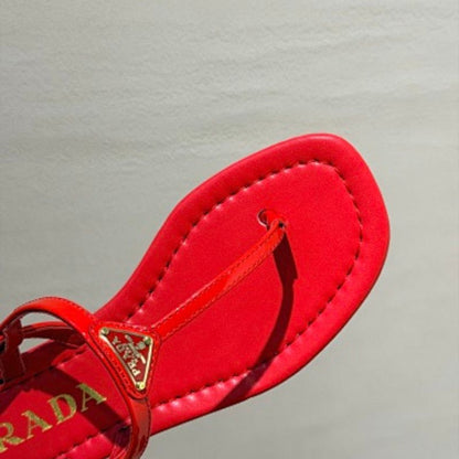 Prada Patent Leather Thong Sandals in a vibrant fiery red ("Fuoco") colorway.