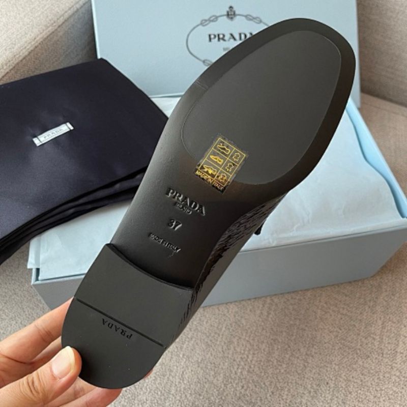 Prada Crinkled Patent Leather Loafers in classic black ("Nero").