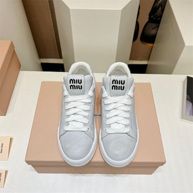 Miu Miu "Bleached Leather" sneakers in white.