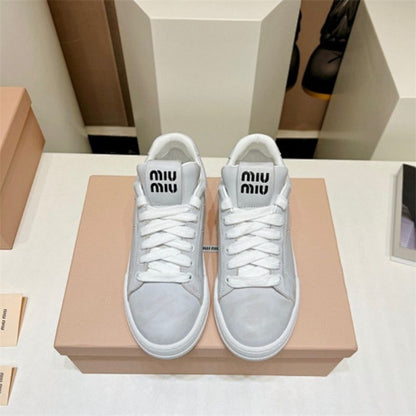 Miu Miu "Bleached Leather" sneakers in white.