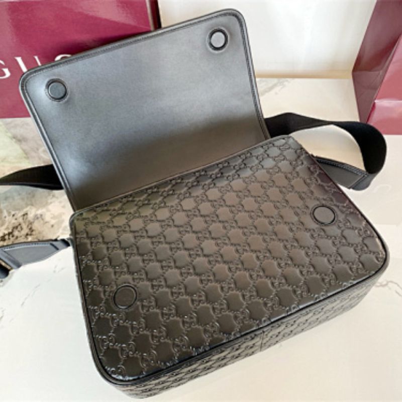 Gucci GG Emblem Medium Crossbody Bag in black embossed GG leather.