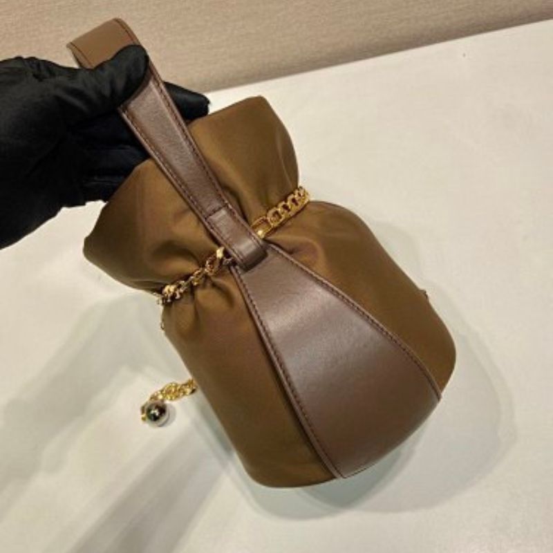 Prada Arqué Re-Nylon and Leather Bucket Bag in a rich cocoa brown.