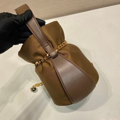 Prada Arqué Re-Nylon and Leather Bucket Bag in a rich cocoa brown.