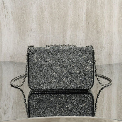 Chanel Rectangular Mini Flap Bag in black glitter.