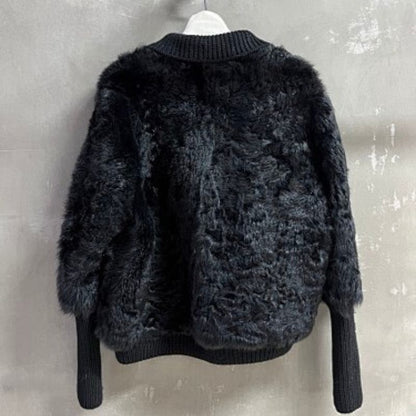 Christian Dior  faux-fur jacket featuring contrasting black knit sleeves, collar, and hem