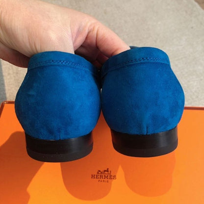Hermès Paris Loafers in a striking monochromatic blue suede layout.