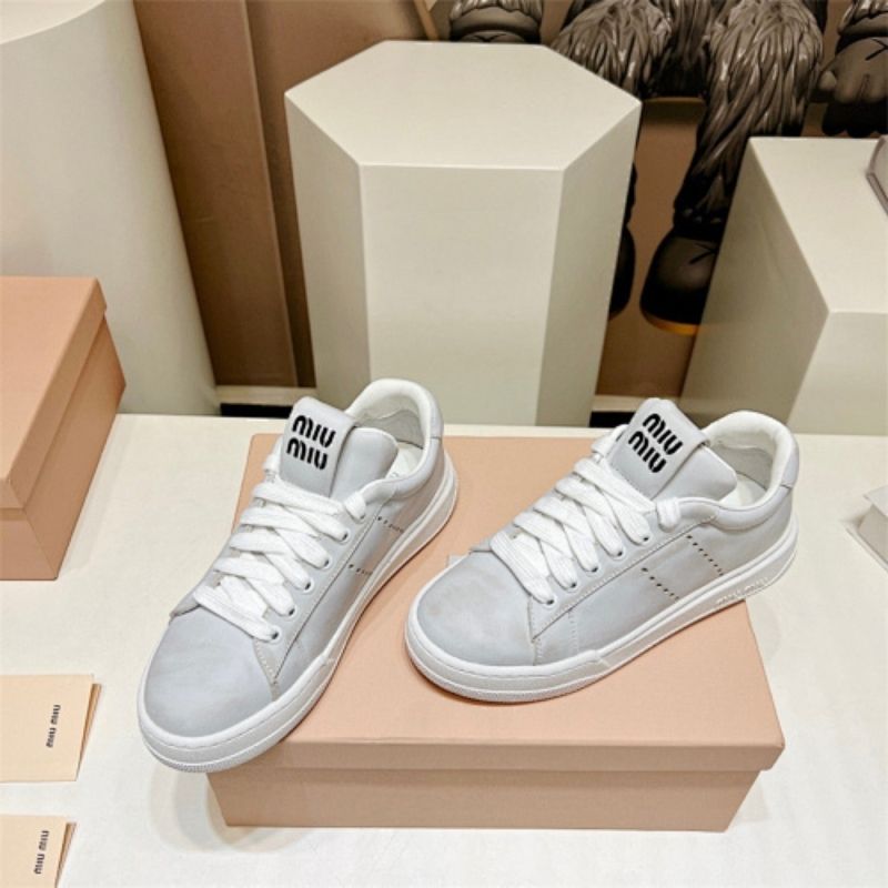 Miu Miu "Bleached Leather" sneakers in white.
