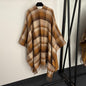 Gucci Reversible GG Wool Poncho in a camel and brown colorway.