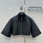 Hermès cropped, short-sleeve leather (or faux leather) jacket.