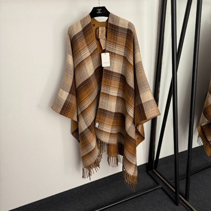 Gucci Reversible GG Wool Poncho in a camel and brown colorway.