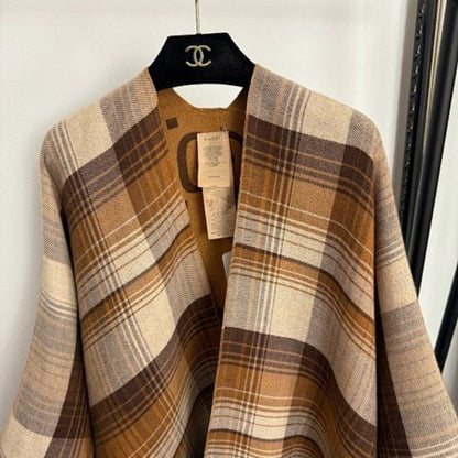 Gucci Reversible GG Wool Poncho in a camel and brown colorway.