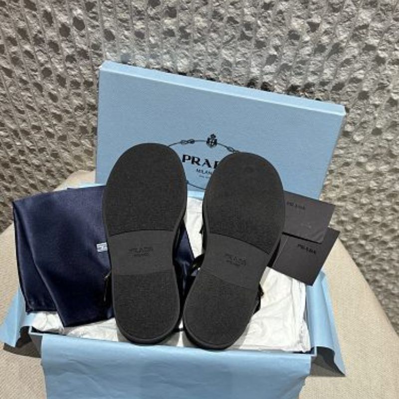 Prada Soft Leather Fisherman Cage Sandals in black.