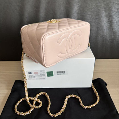 Chanel Small Classic Quilted Vanity Case in a light pink hue.