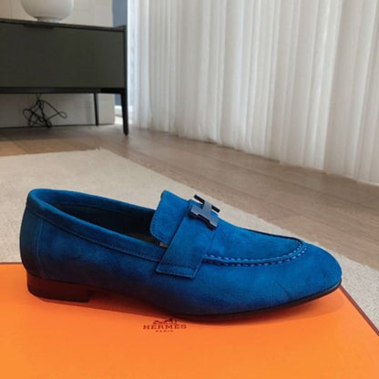 Hermès Paris Loafers in a striking monochromatic blue suede layout.