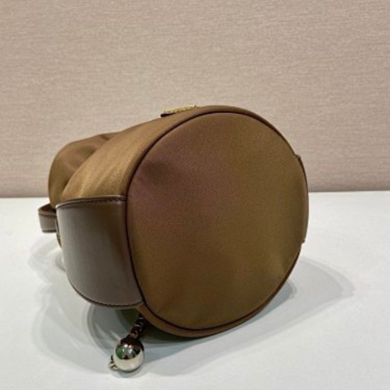 Prada Arqué Re-Nylon and Leather Bucket Bag in a rich cocoa brown.