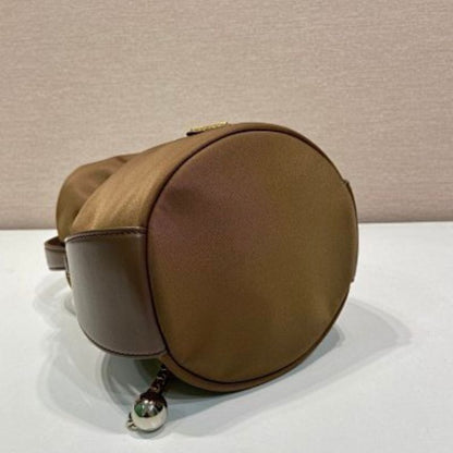 Prada Arqué Re-Nylon and Leather Bucket Bag in a rich cocoa brown.