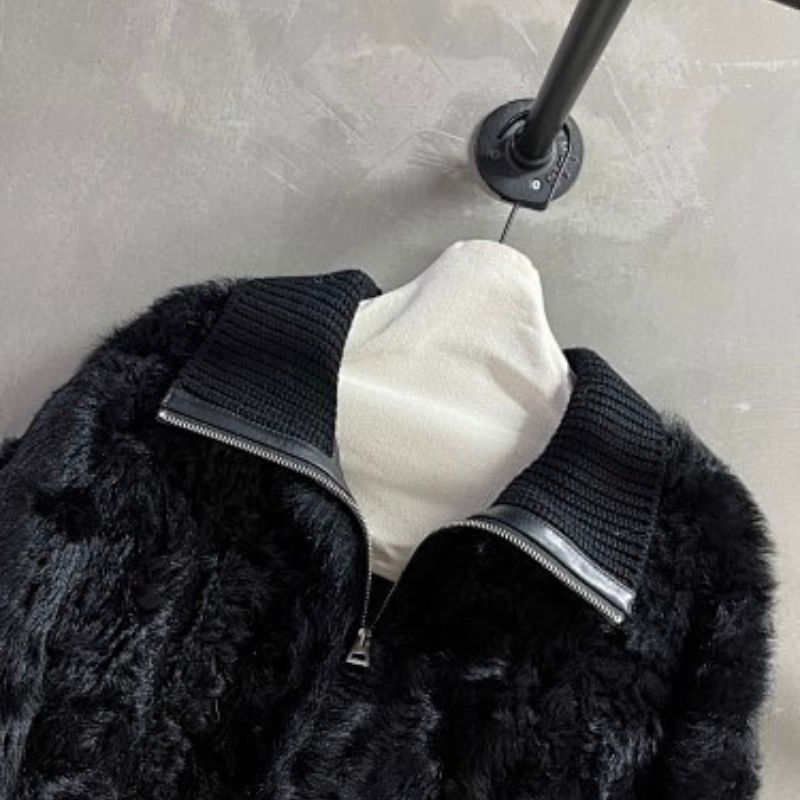 Christian Dior  faux-fur jacket featuring contrasting black knit sleeves, collar, and hem